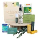 Assortment of natural health and personal care products displayed on a round pedestal, including Koala Eco hand and surface sanitiser and eucalyptus tea boxes, lozenges, and lip balm.