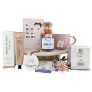 A Hug In A Box Gift Hamper with mug, tea, handcream, book, ornament and bear hug lolly treats
