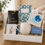 Send A Hug Gift Hamper sitting on a coffee table open
