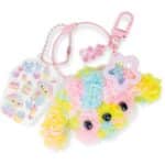 Pastel rainbow fluffy pom-pom keychain with a pink clasp and star charm.