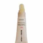 Nipple balm tube labeled Bare Mum with a pale cream on the applicator tip.