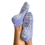 Purple socks with white abstract patterns on the soles, shown stretched over crossed feet in a product photo.