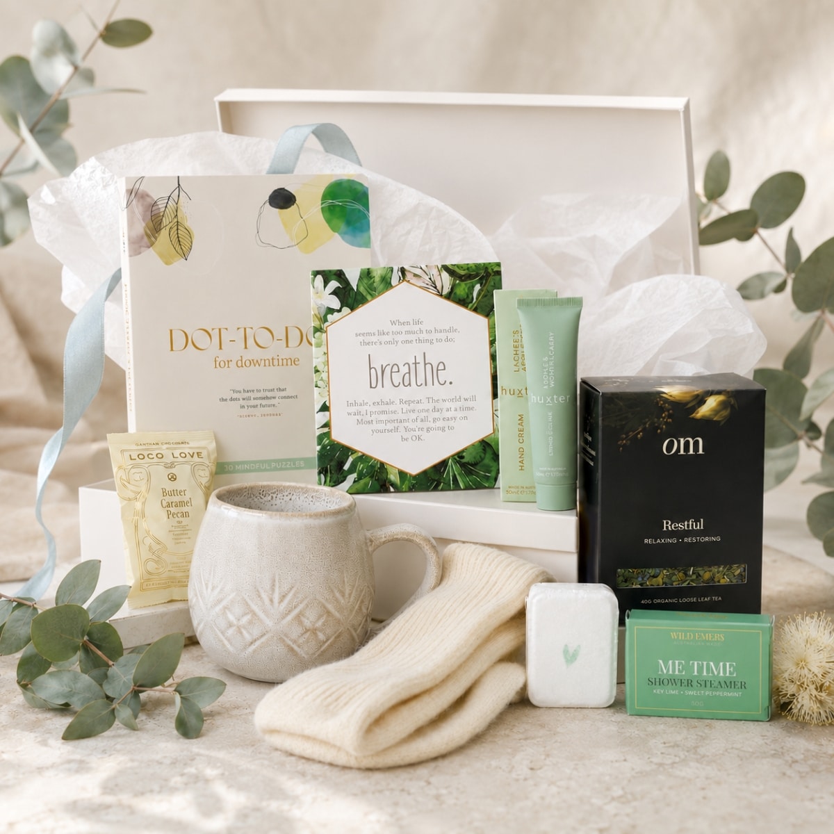 Thoughtfully presented Sending Hugs thinking of you hamper with comforting tea, a mug, self-care products and keepsakes.
