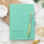 wellness journal with aventurine crystal pen on top