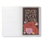 Open notebook with lined left page and a floral motto card on the right reading 'SAVOR EVERY ACTION' (brown card with red/pink flowers).