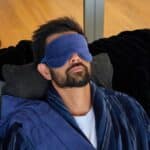 Navy velvet sleep mask for men styled as a relaxing bedtime and self-care gift.