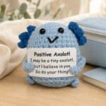 Positive Axolotl mini crocheted plush support on desk