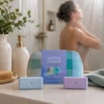 Shower Steamer & Cosmetic Bag Gift Set On Vanity Whilst Someone enjoying one in the shower