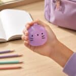 Hand squeezing the purple Squishy Jelly Cat sensory fidget toy