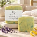Lavender and Litsea handmade soap styled with lavender sprigs and fresh citrus in a softly lit bathroom
