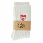 Cloud-soft cream ribbed socks finished with a red heart embraced by embroidered hugging arms.