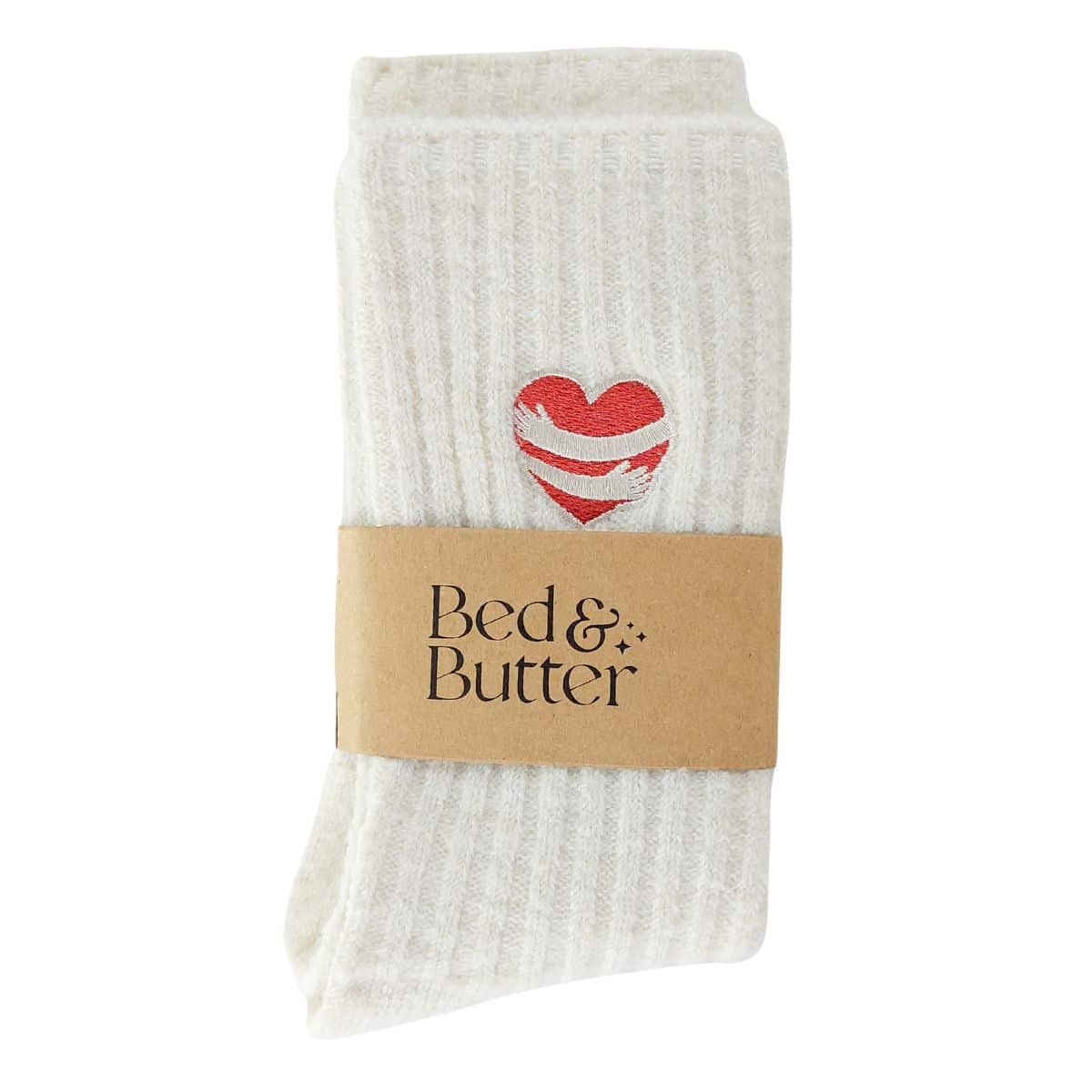 Cloud-soft cream ribbed socks finished with a red heart embraced by embroidered hugging arms.