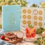 Australian Cold Infusions Tea Christmas Advent Calendar displayed with loose leaf tea tins and a refreshing glass of iced tea in a festive setting