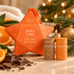 Jaffa Mini Lip Balm Duo Star with orange and chocolate natural lip balms displayed in a warm Christmas setting, ideal for stocking fillers and festive gifts.