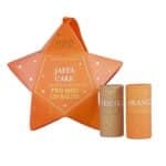 Jaffa Mini Lip Balm Duo Star Christmas ornament in orange and gold packaging containing two natural orange and chocolate vegan lip balms.
