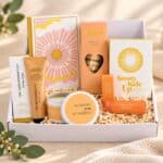 Sending Sunshine Self-Care Gift Hamper arranged in an open white gift box with uplifting keepsakes, pampering essentials and sweet treats.