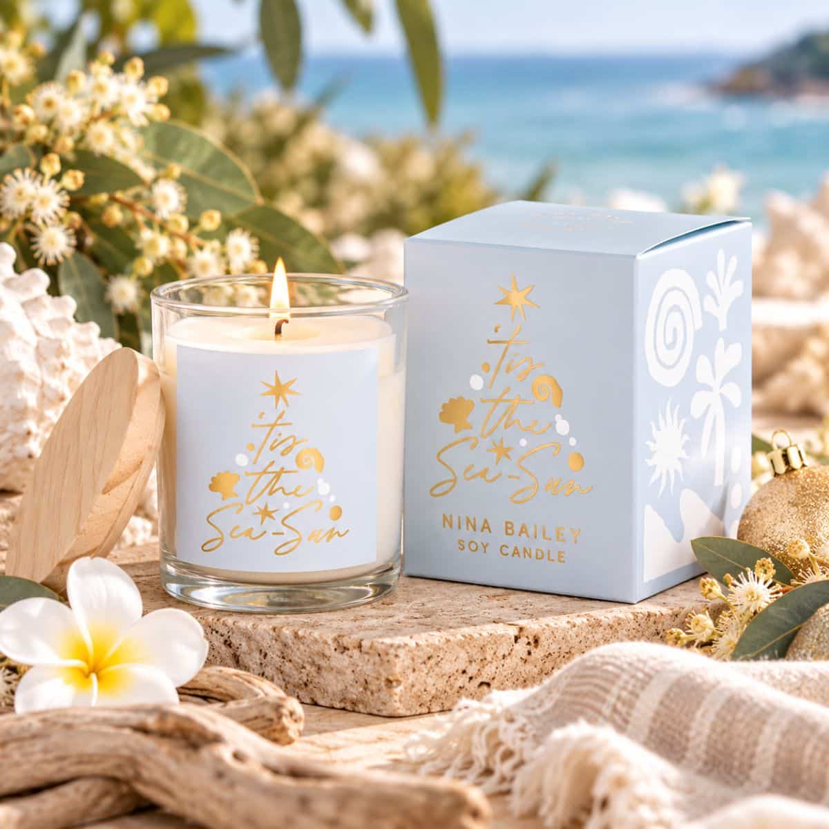 Australian-made Coastal Christmas Candle with white driftwood and coconut fragrance styled in a relaxed summer Christmas setting